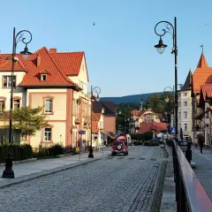 Urokliwa ulica w Świeradowie-Zdroju, z charakterystyczną architekturą i brukowaną nawierzchnią. Idealne miejsce na spacer po okolicy Jeleniej Góry.